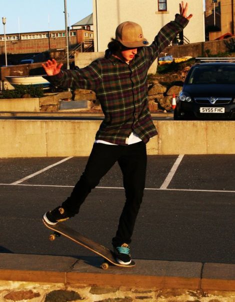 Mike Williamson performs a nose manual outside the museum. Pic. Scott Goudie