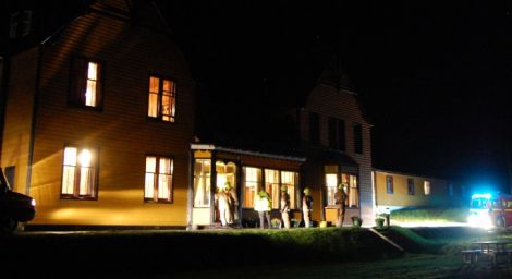 Fire crews examine the smoke damaged porch at Hillswick's St Magnus Bay Hotel on Friday night.