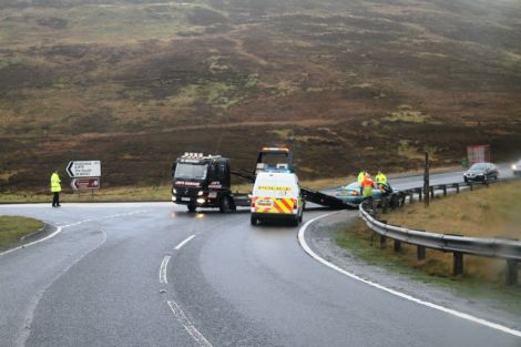 Police clear away a vehicle at Brig o Fitch after Monday morning's rush hour crash. Pic. Geoff Leask