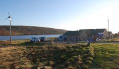 A Proven P11 six kilowatt wind turbine turns at Urafirth primary school, one of two installed for Shetland Islands Council by Shetland Windpower Ltd.