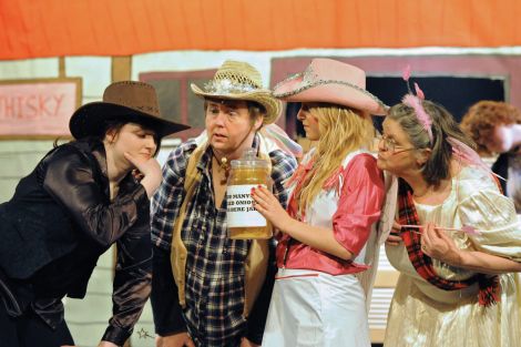 Trusty Jude (Shaela Halcrow), Fairy Buckaroo (Kathy Hubbard), Fairy Yeehaw (Danielle Warham) and Fairy Howdy (Ann Thomson) ponder a problem in Sleeping Beauty in the Wild West. Pic. Malcolm Younger