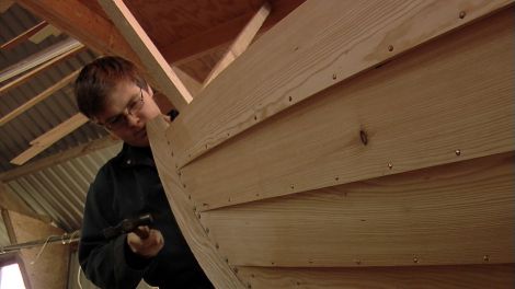 Concentrate! Tom hammers in one of the last copper nails