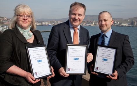 Jennifer Mouat of the SSMO, Richard Lochhead and Martin Robinson show off the MSC certificates for king scallops, brown and velvet crabs. Pic. Billy Fox