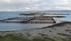 Four salmon cages belonging to Lakeland Unst washed up at Skea, North Roe, after coming loose during a tow on Monday night. Pic. Shetland News