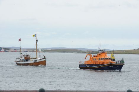 The Shetland Bus vessel Heland being towed into Lerwick harbour on Sunday morning.