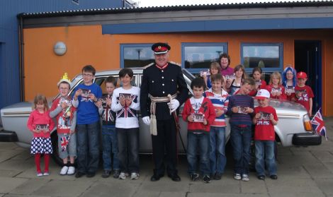 Lord Lieutenant Bobby Hunter and all 15 Nesting primary pupils who gave up a day off school for the jubilee celebrations. Behind them is Philip Gifford's silver Volvo hot from the Classic Motor Show. The same car starred in Shetland's silver jubilee celebrations in 1977. Pic. Kate Coutts