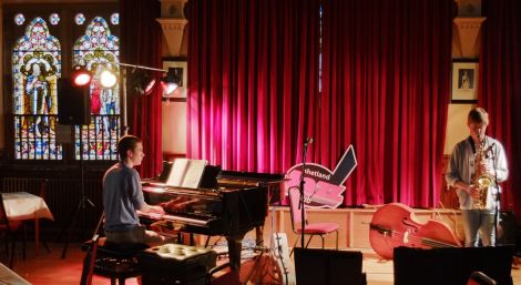 Stained glass knights watch Norman Willmore (sax) and Max Tyler rehearse for the gala night show. Pic. Chris Brown