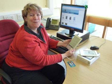 Librarian Marghie West tries out an eReader. Pic. SIC