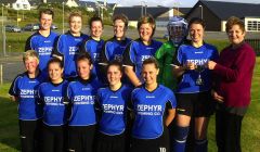 Dianne Davies presents the Mid Brae Inn cup to Whalsay. Back row: Ellie Simpson, Shelley Sandison, Natalie Polson, Emily Henderson, Deborah Mowat, Dianne Shearer, Maree Simpson (captain,) Diane Davies. Front row: Angelina Jamieson, Zoe Irvine, Nicola Duthie, Abbey Irvine, Catherine Williamson