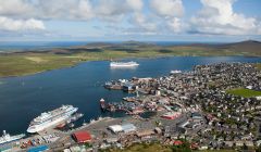 A busy day at Lerwick Harbour this summer, with three cruise ships in port - from left to right, AIDACara (alongside Holmsgarth), MSC Poesia (at anchor) and National Geographic Explorer (alongside Victoria Pier) - Photo: John Coutts/LPA