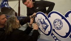 Guizer Jarl Stevie Grant knocking the last nail into the galley on Monday, closely watched by two of the galley squad - Photo: Olivia Abbott