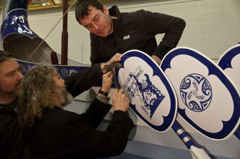 Guizer Jarl Stevie Grant knocking the last nail into the galley on Monday, closely watched by two of the galley squad - Photo: Olivia Abbott