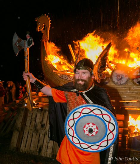 Uyeasound Guizer Jarl Colin Jamieson with his burning galley Uresvik - Photo: John Coutts