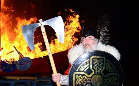 Guizer Jarl John Laurenson with his burning galley Aumstr - Photo: Mark Berry