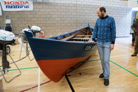 Shetland museum curator Dr Ian Tait admiring the cod boat Ann LK126, the rarest and second oldest Shetland boat in existence - Photo: Austin Taylor