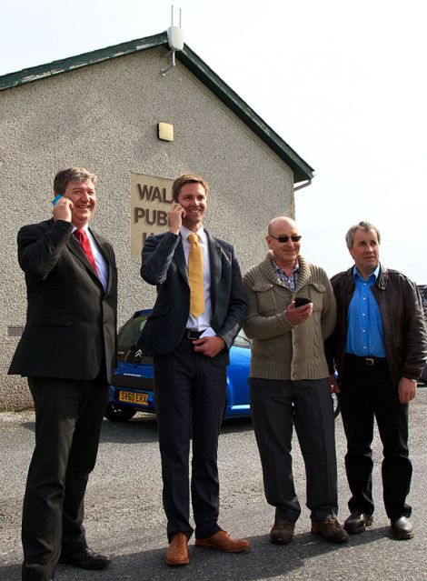 Getting connected in Walls (from left to right): isles MP Alistair Carmichael, John McCracken of Vodafone, as well as Doug Forrest and Ian Walterson of the Sandness and Walls Community Council - Photo: Olivia Abbott/ShetNews