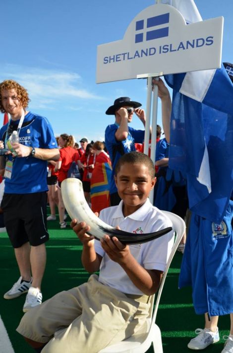 Standard bearer and team mascot Aaron holding the horn in which Andrea Strachan delivered Shetland's pint (of water) for the opening ceremony. Photo Andrew Inkster