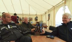 Sailors George, Dave and Decland enjoy Lerwick Brewery's new beer at the Skeld Regatta on Friday. Photo Olivia Abbott