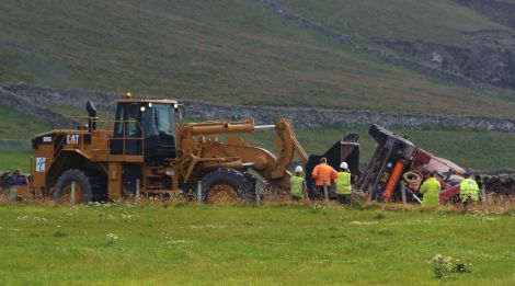 The concrete mixer is being bulldozed off the road - Photos: Ronnie Robertson