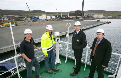 Handing over of Mair’s Quay (left to right): Tulloch Developments directors Alistair Tulloch and George Smith; Lerwick Port Authority harbourmaster Captain Calum Grains, and Andy Sandison of Arch Henderson LLP.