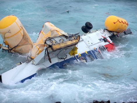 Air accident investigators say the helicopter broke up when when washed against the rocky shoreline - Photo: Peter Hutchison/ShetNews