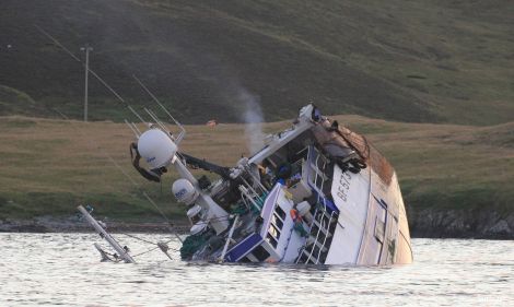 Prospect sinks on Monday night having been holed after running into the well-marked Skibby Baa in Lerwick harbour's north entrance. Photo Ian Leask