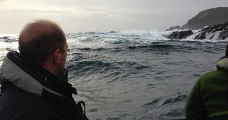 The heavy swell at Garths Ness that delayed recovery of the tail section with its black box. The men in the picture are from the Air Accident Investigation Branch. Photo John Henderson