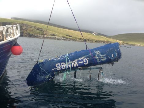 The tail section of the dismembered Suoer Puma helicopter being lifted onto the workboat Koada. Photo John Henderson