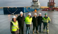 Left to right – Sandra Laurenson, Chief Executive, Lerwick Port Authority; Captain Calum Grains, Harbourmaster, Lerwick Port Authority; George Smith, Director, Tulloch Developments Limited; Andy Sandison, Partner Arch Henderson LLP; Alistair Tulloch and Frank Tulloch, Directors, Tulloch Developments Limited, at the new quay, with the standby vessel Sea Trout in the background - Photo: LPA