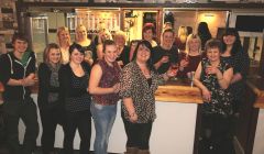 The Mid Brae Inn staff raise a glass to congratulate owner Diane Davies (second from right) on the re-opening of the restaurant - Photo: Gordon Stove