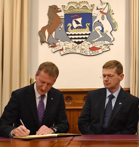 Shetland MSP Tavish Scott (left) and council convener Malcolm Bell signing the book of condolence in Lerwick town hall on Monday - Photo: BBC