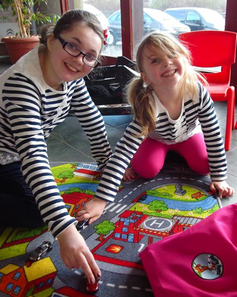 Rebekah and (right) Joanna Tregonning test drive the toys provided by Peerie Foxes for the waiting area.