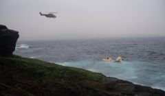 A Jigsaw search and rescue helicopter flies over the Super Puma crash site - Photo: Peter Hutchison/ShetNews