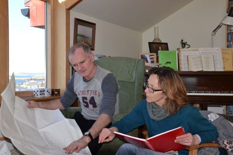 The couple examine the charts and logbook Andrew managed to recover before being airlifted from the Elsi Arrub. Photo: Neil Riddell/Shetnews