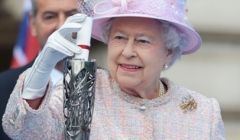 The Queen places her message in the Commonwealth Games baton before it set off on its world tour last October.