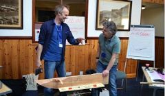 'Axe wielding Halgeirr Bjørnevik (left) demonstrating traditional boat building techniques to PhD student Marc Chivers.