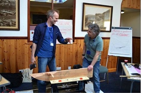 'Axe wielding Halgeirr Bjørnevik (left) demonstrating traditional boat building techniques to PhD student Marc Chivers.