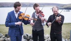 Nordic Fiddlers' Bloc, featuring Shetlander Kevin Henderson (centre), enjoying the fresh Fetlar air ahead of their Friday night concert. Photo: Floortje Robertson