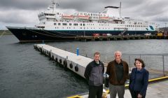 The temporary pontoon donated by Hjaltland Seafarms with (from left) deputy harbourmaster Alexander Simpson, Hjaltland managing director Sigurd Pettersen and port chief executive Sandra Laurenson. Photo LPA