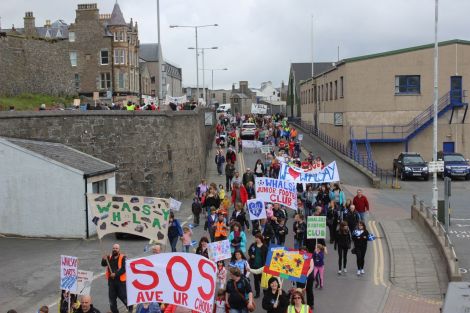 Demonstrators march through Lerwick last month to celebrate rural education and dissuade the SIC from their closure and other cost saving plans. Photo Shetnews