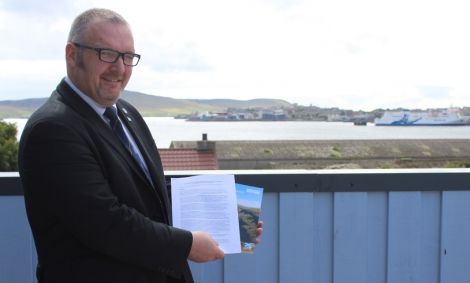 Shetland Islands Council leader Gary Robinson holds up the two pledges from the UK and Scottish governments for greater island powers following the independence referendum.