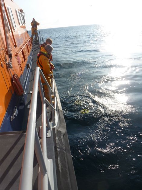 A poignant scene as wreaths are laid at sea in the area where the helicopter ditched 12 months ago. Photo courtesy of RNLI