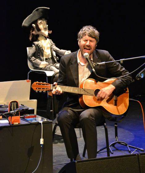 Gruff Rhys regaling a warmly receptive audience at Mareel, as a felt doll of explorer John Evans looks on. Photo: Shetnews/Kelly Nicolson Riddell