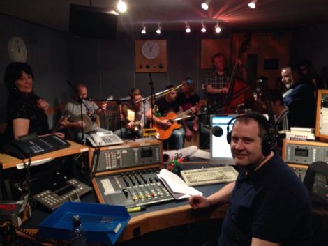 John Johnston in the chair at the end of a long night, with fellow broadcaster Jane Moncrieff (left) and a whole bunch of musicians from Hom Bru and The Revellers.