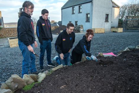 Filling in the planters are (from left) local neighbour Frank Johnson, Luke Smith, Stewart Hornal and Holly King - Photo: Austin Taylor.