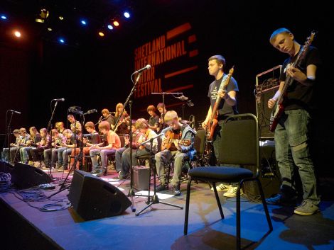 High Level Music students packing the stage at the festival-closing "guitar heroes" concert. Photo: Chris Brown