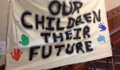 Protesters hung a banner on the stairs of Lerwick Town Hall on Wednesday morning. Photo: Shetnews