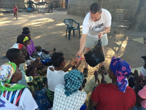 Wylie hands out wind up torches in Malawi this year to help people attend medical services after dark.