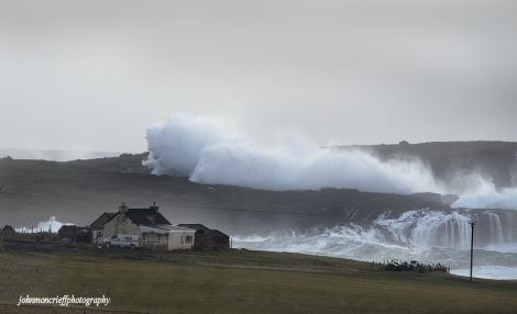 Waves towering over a croft building at Eshaness - Photo: John Moncrieff