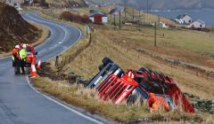 Workmen consider how to retrieve the Garriock Brothers' low loader that came off the A970 on Monday. Photo Ronnie Robertson